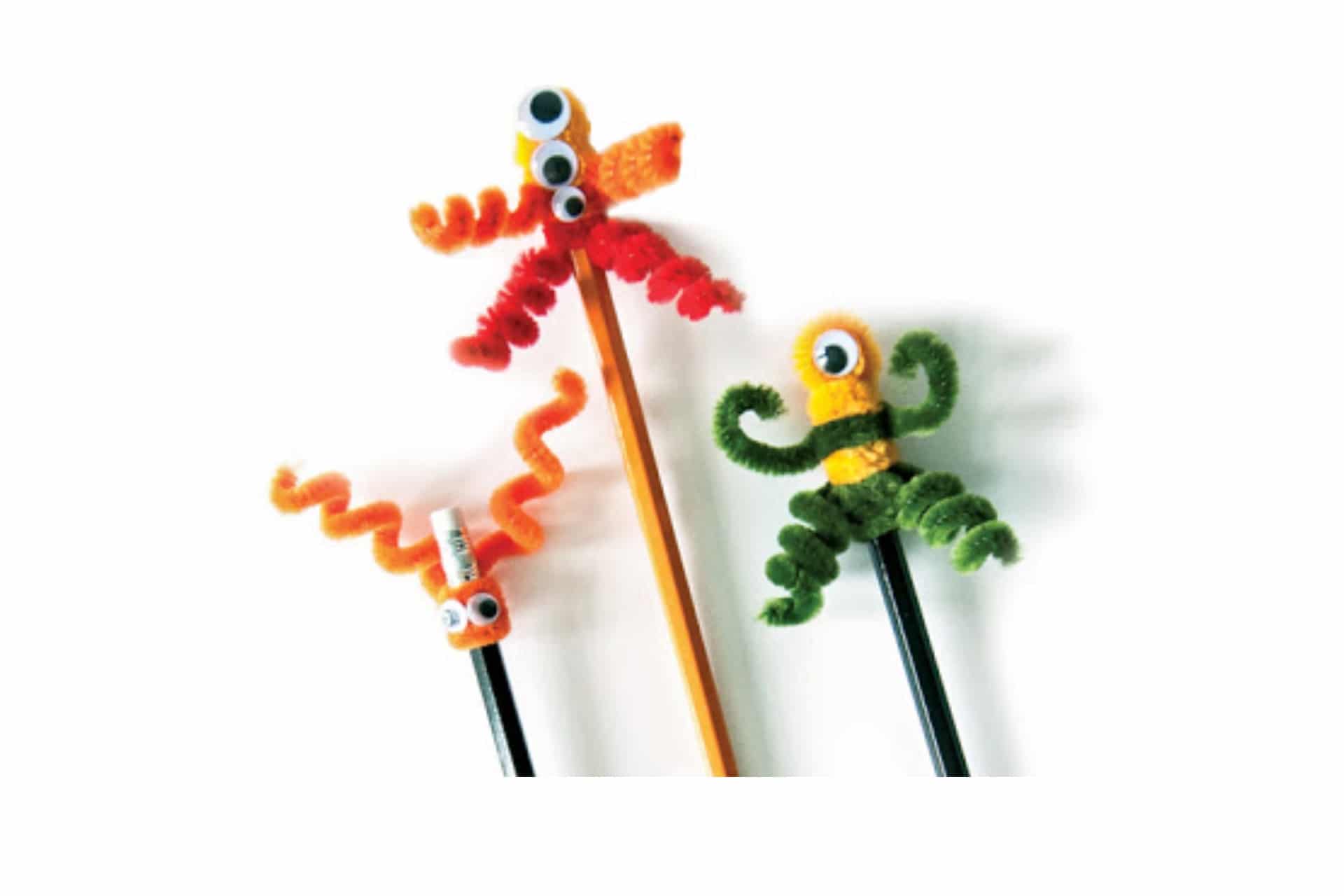 pipecleaner bent into shapes on top of pencils