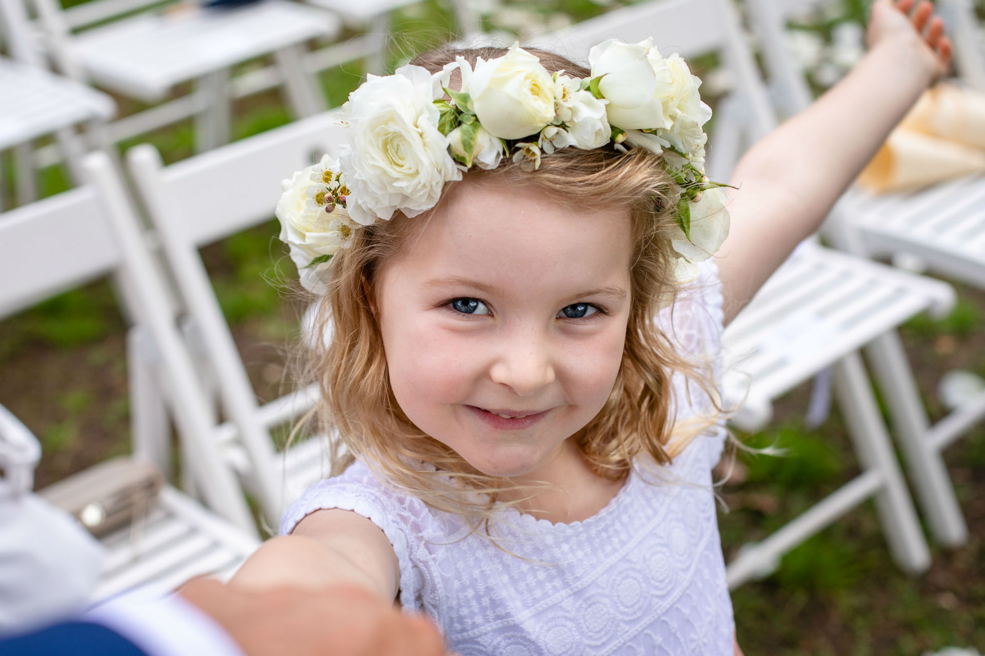 little girl at a wedding with flower crown