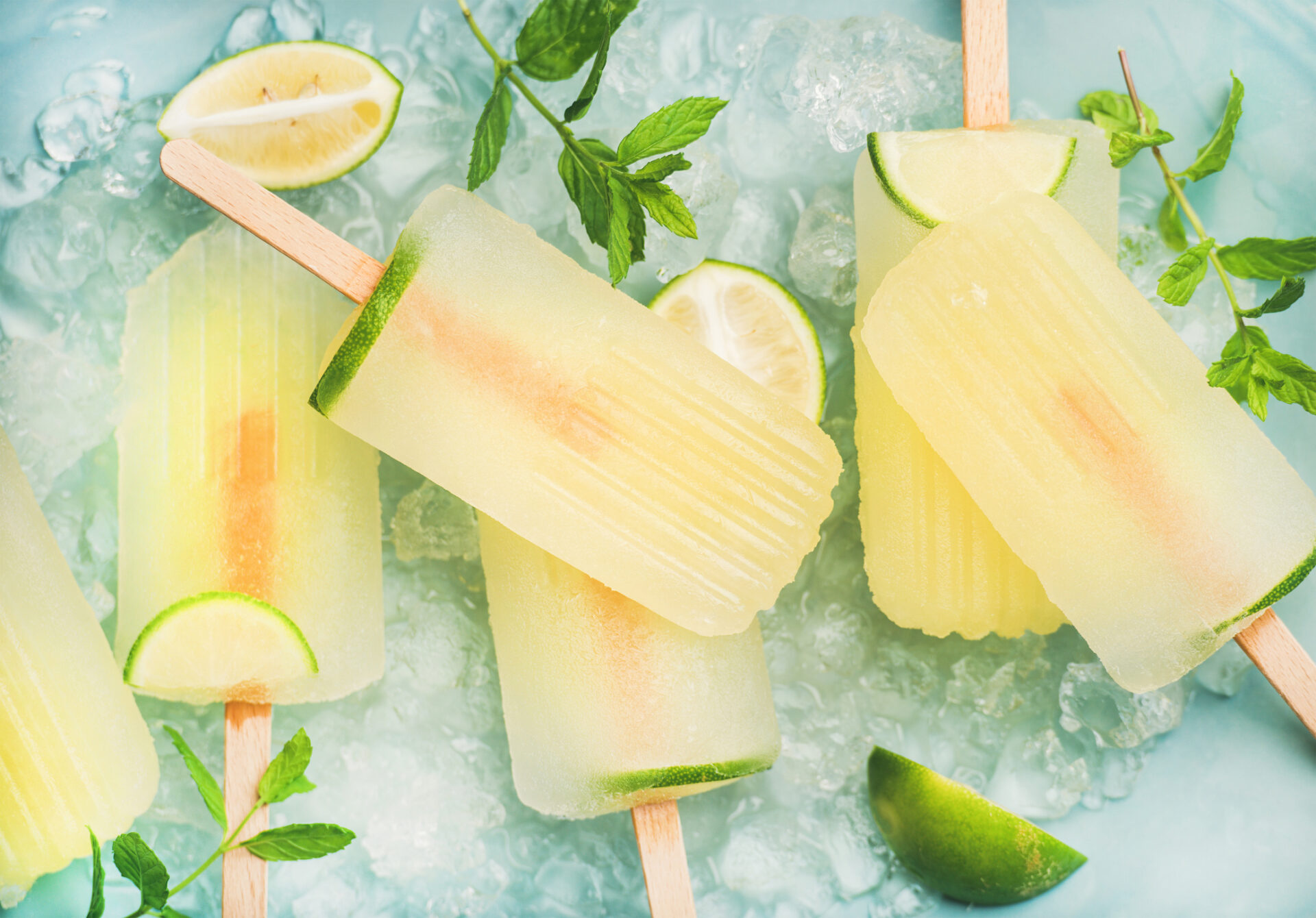 Gin and tonic popsicles on light blue background