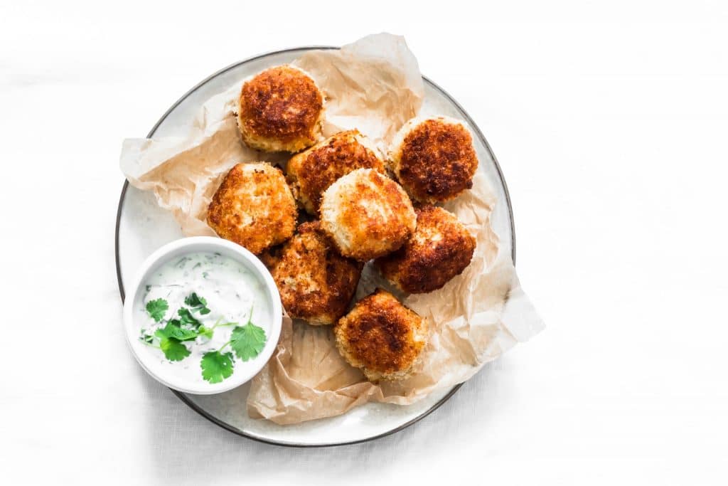 Tuna cakes on a plate with aioli to dip