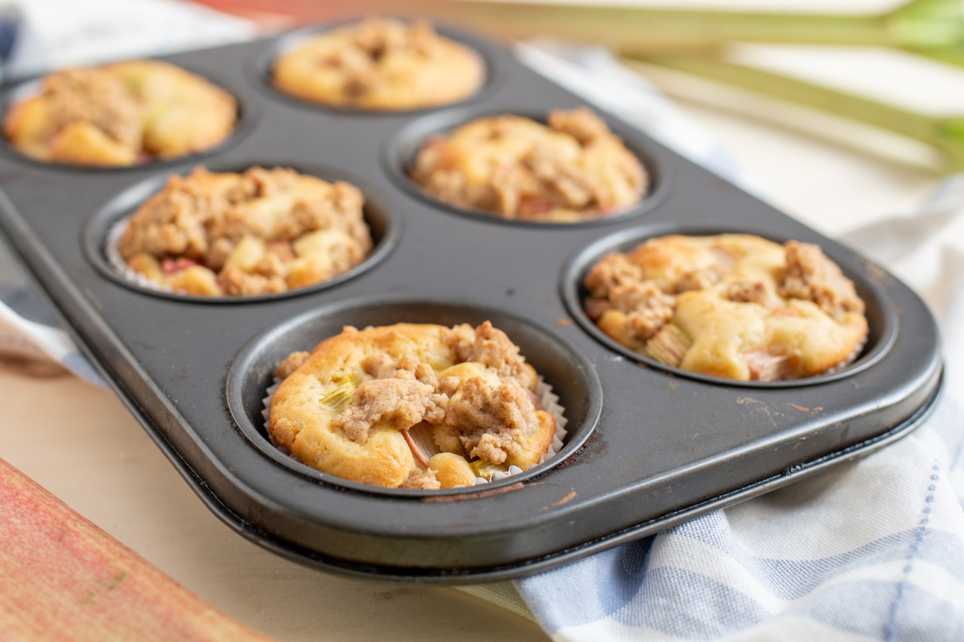 Rhubarb muffins in a baking tin waiting to be eaten
