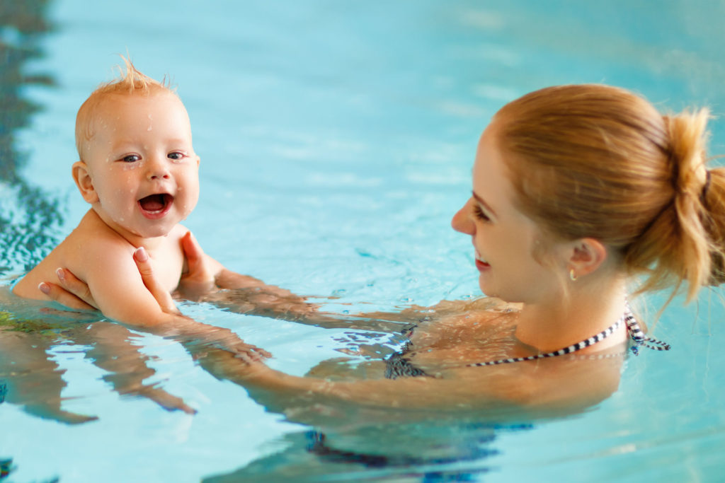 mom and baby in a swimming pool