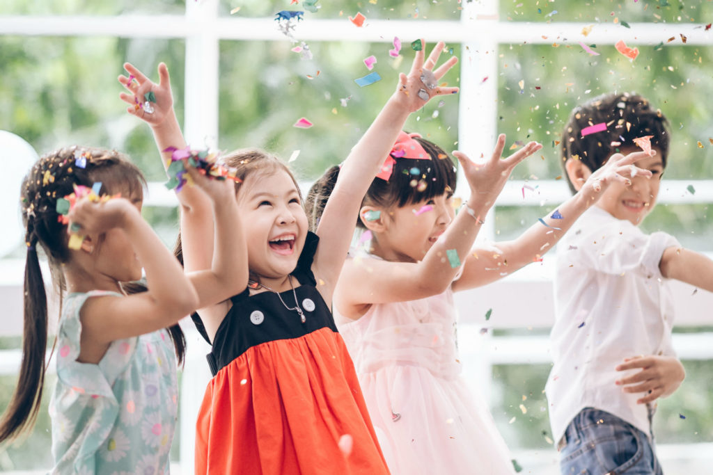 kids at a birthday party throwing confetti