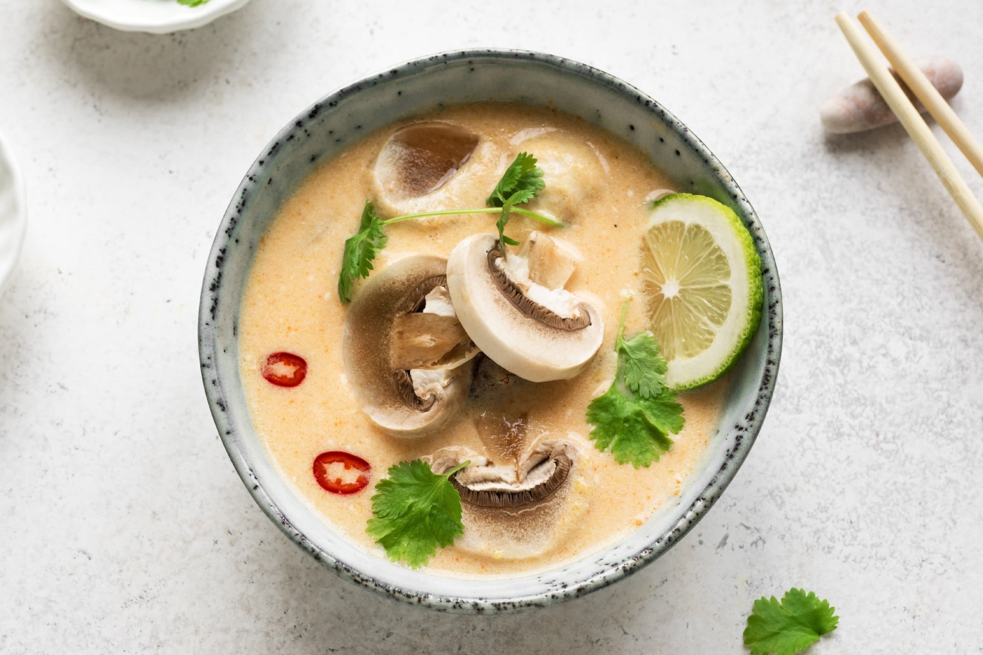 Bowl of chicken and veg thai soup in a creamy coconut milk broth