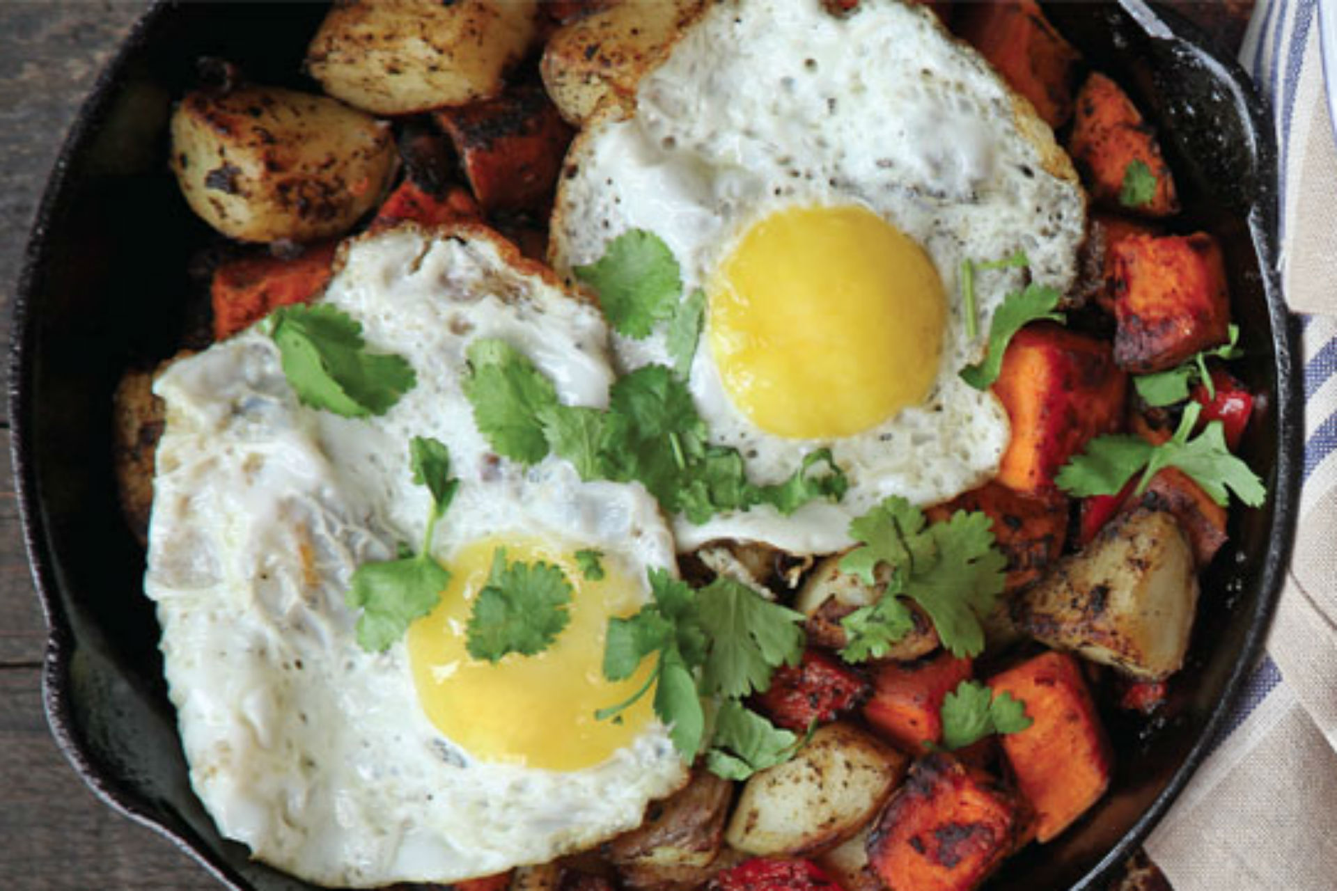 frying pan with potatoes and an egg