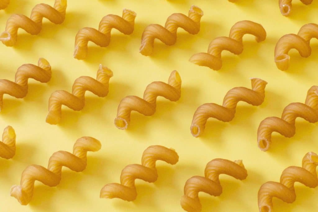 dried pasta flat lay shot on a yellow background