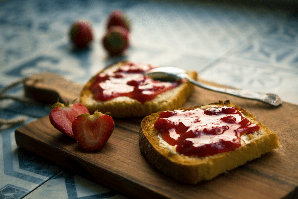 toast with strawberry jam on a cutting board