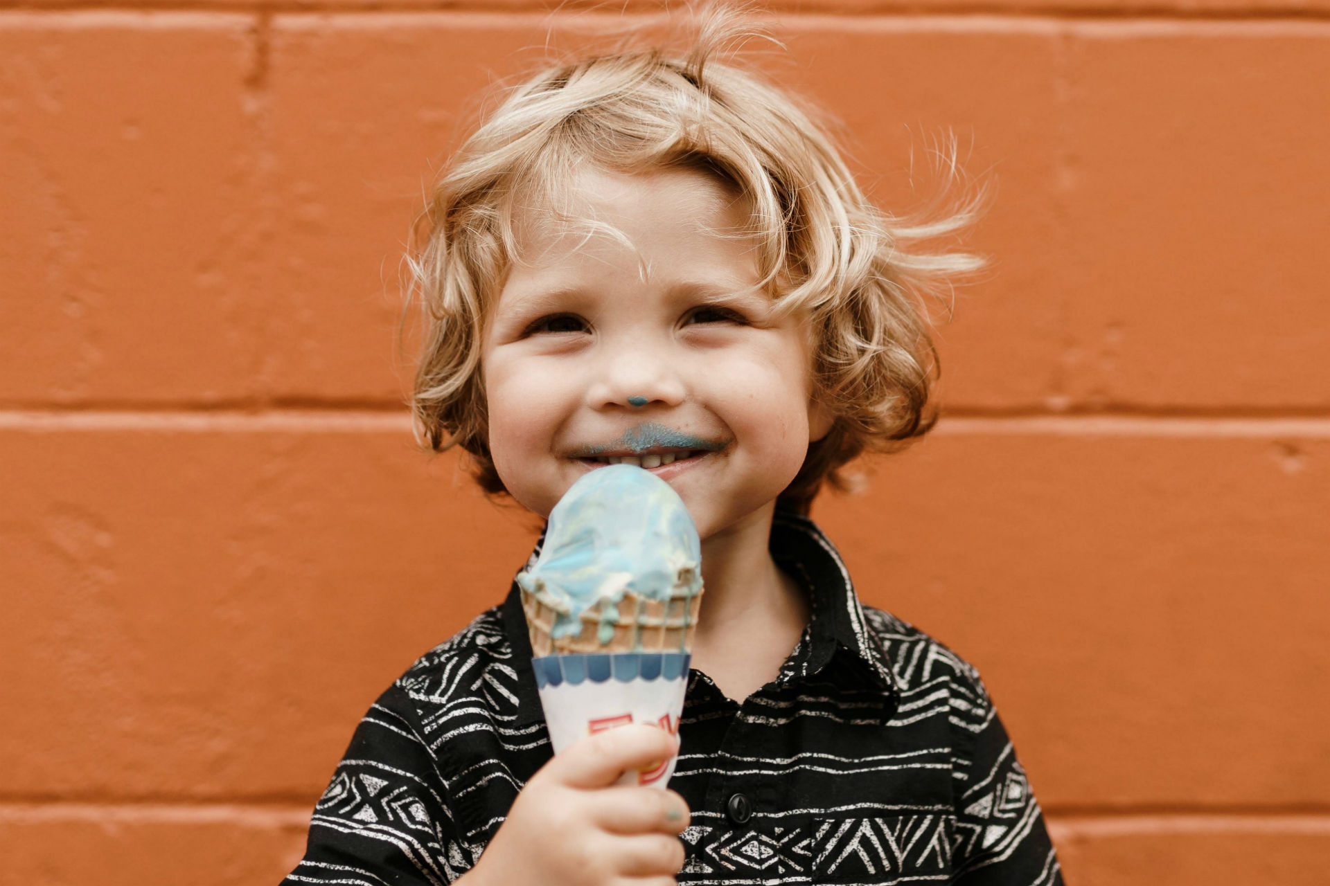 little boy eating an ice cream cone