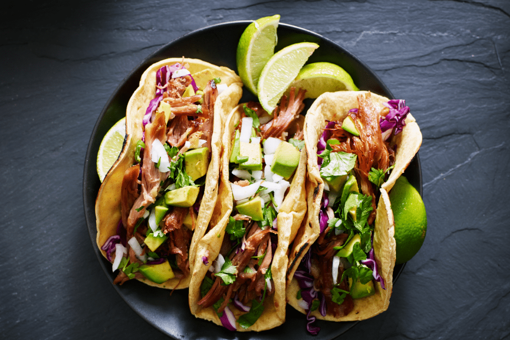 tacos with pulled pork, ciltro, red cabbage and lime