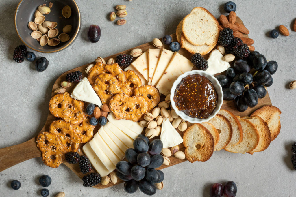 cheeseboard with crackers, fruit and grainy mustard