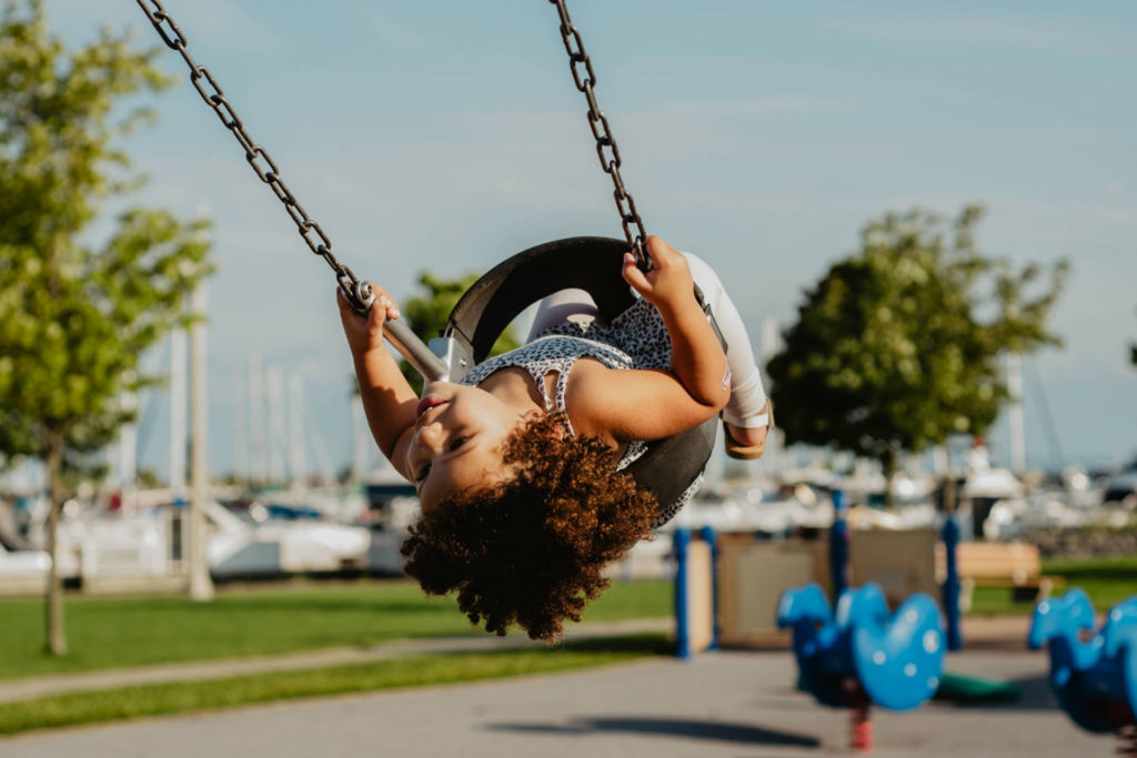 toddler on a swing practicing summer safety 101