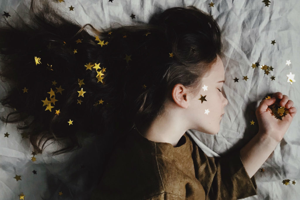 little girl sleeping with gold dust in hair