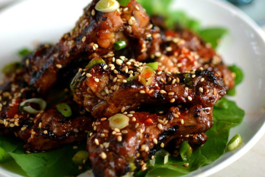 pile of chicken wings with sesame seeds