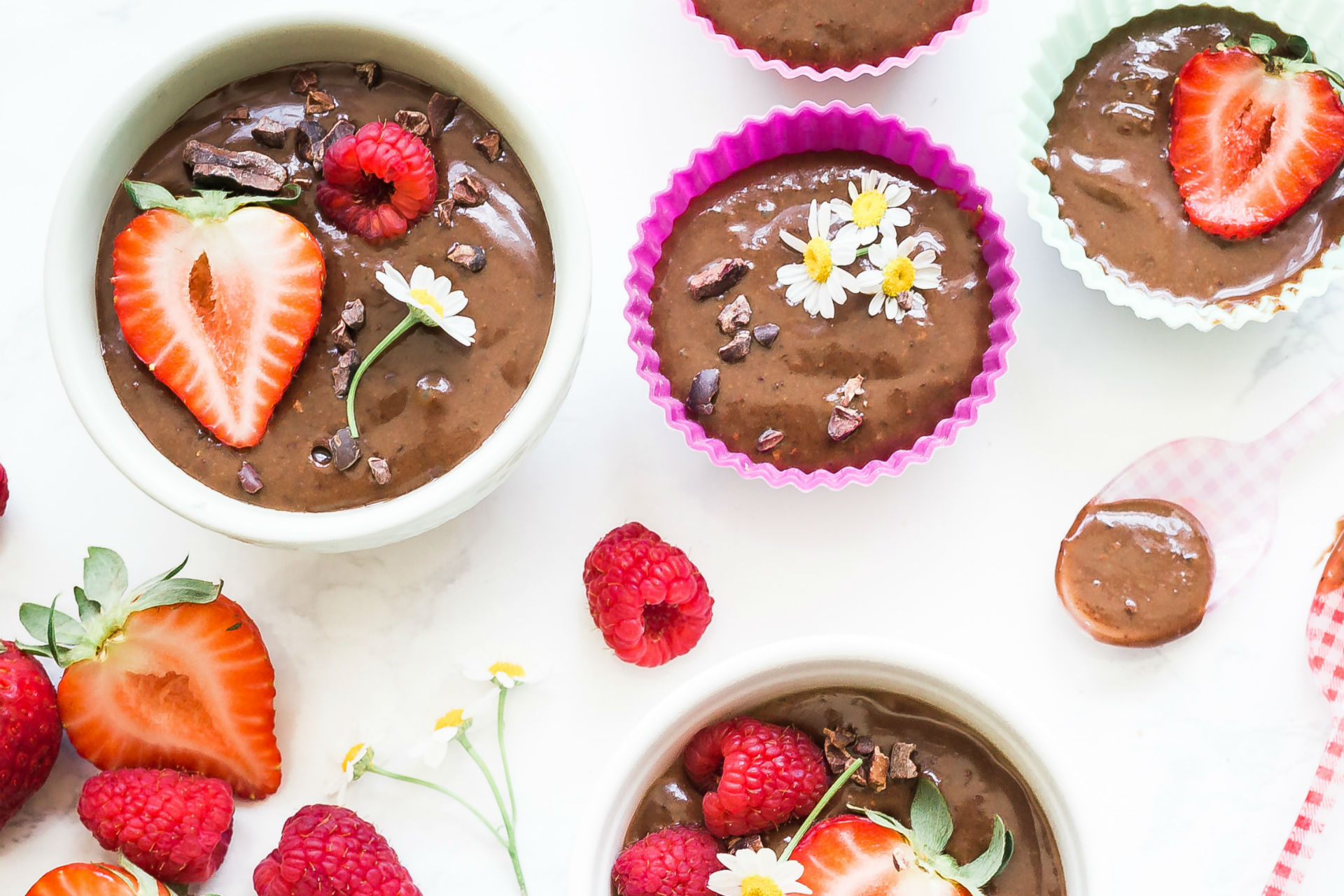 bowls of chocolate pudding with berries