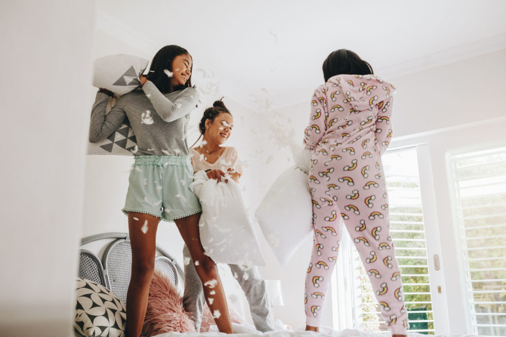 Are sleepvers good or bad? Girls pillow fighting standing on bed
