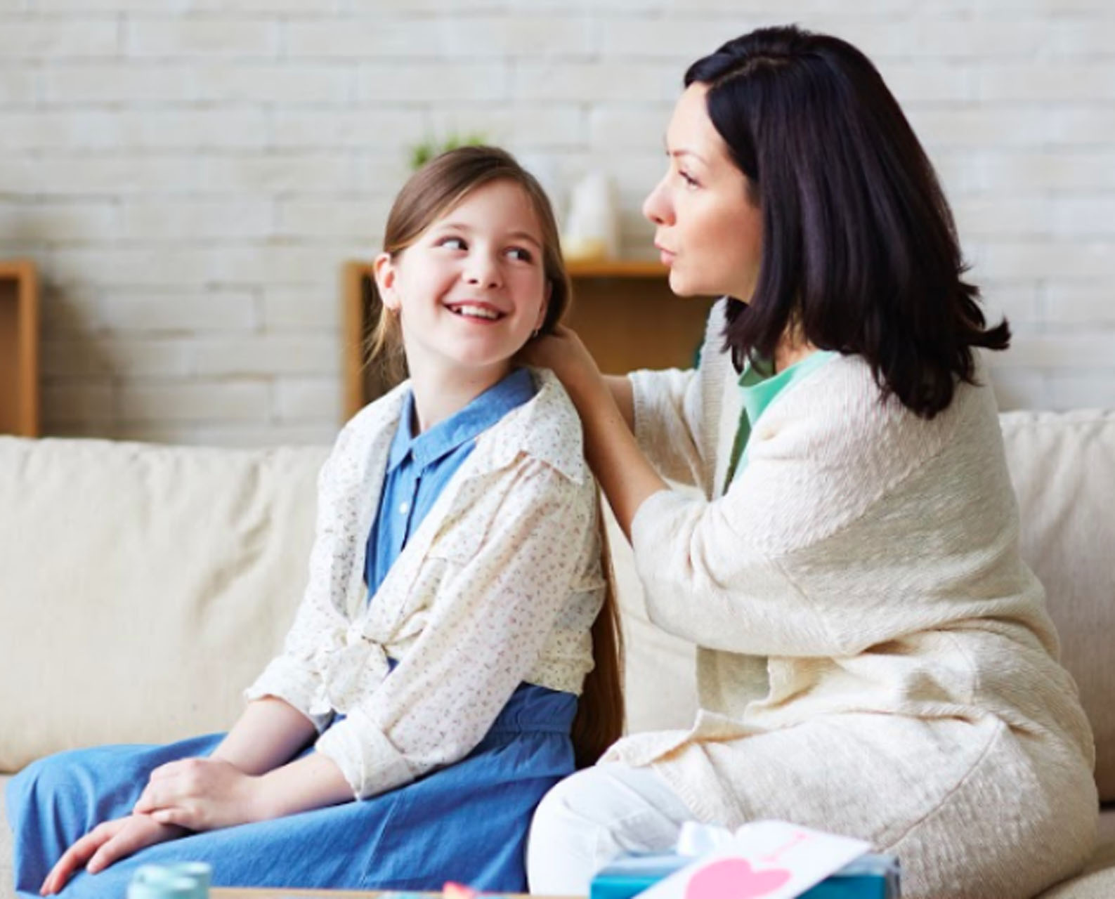 a couple sits with positive pregnancy test