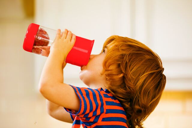 Child drinking out of munchkin fruit infuser cup