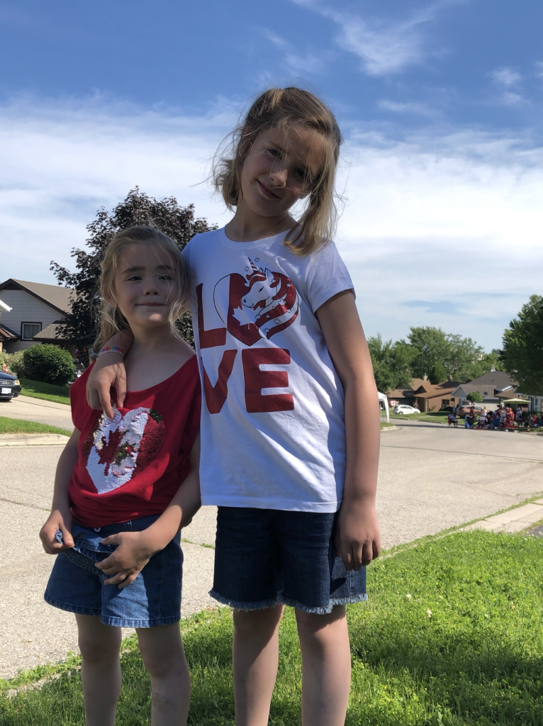 Two girls standing outside in summer