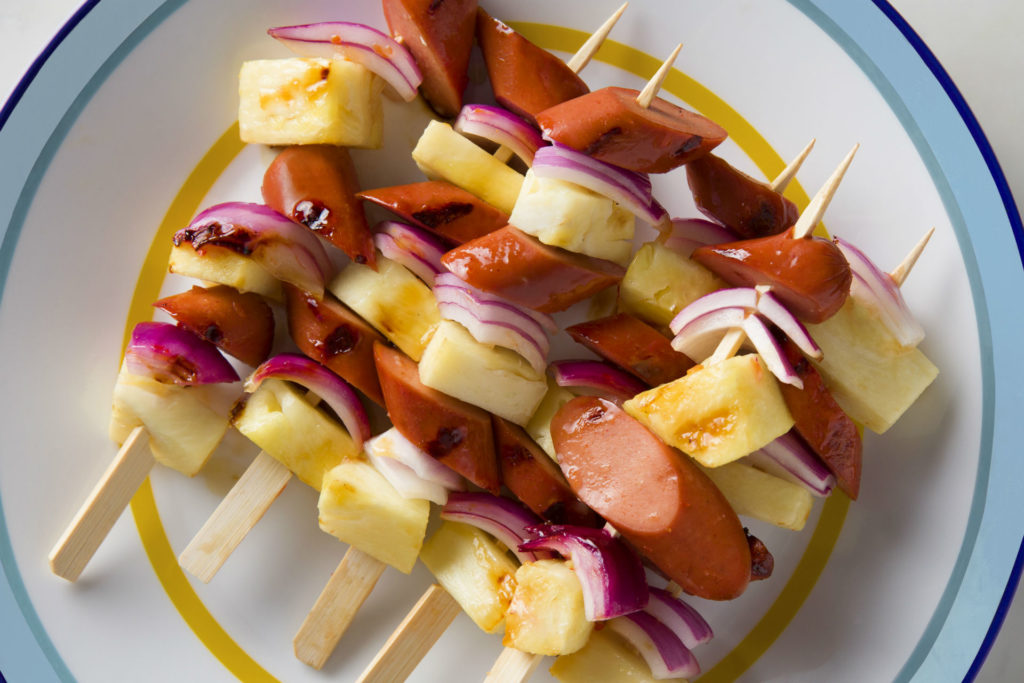 kebobs with hot dog, pineapple and red onion