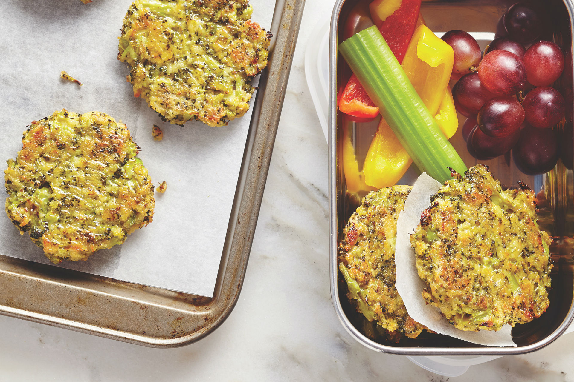 broccoli and cheese patties in a lunch box with fruits and veggies