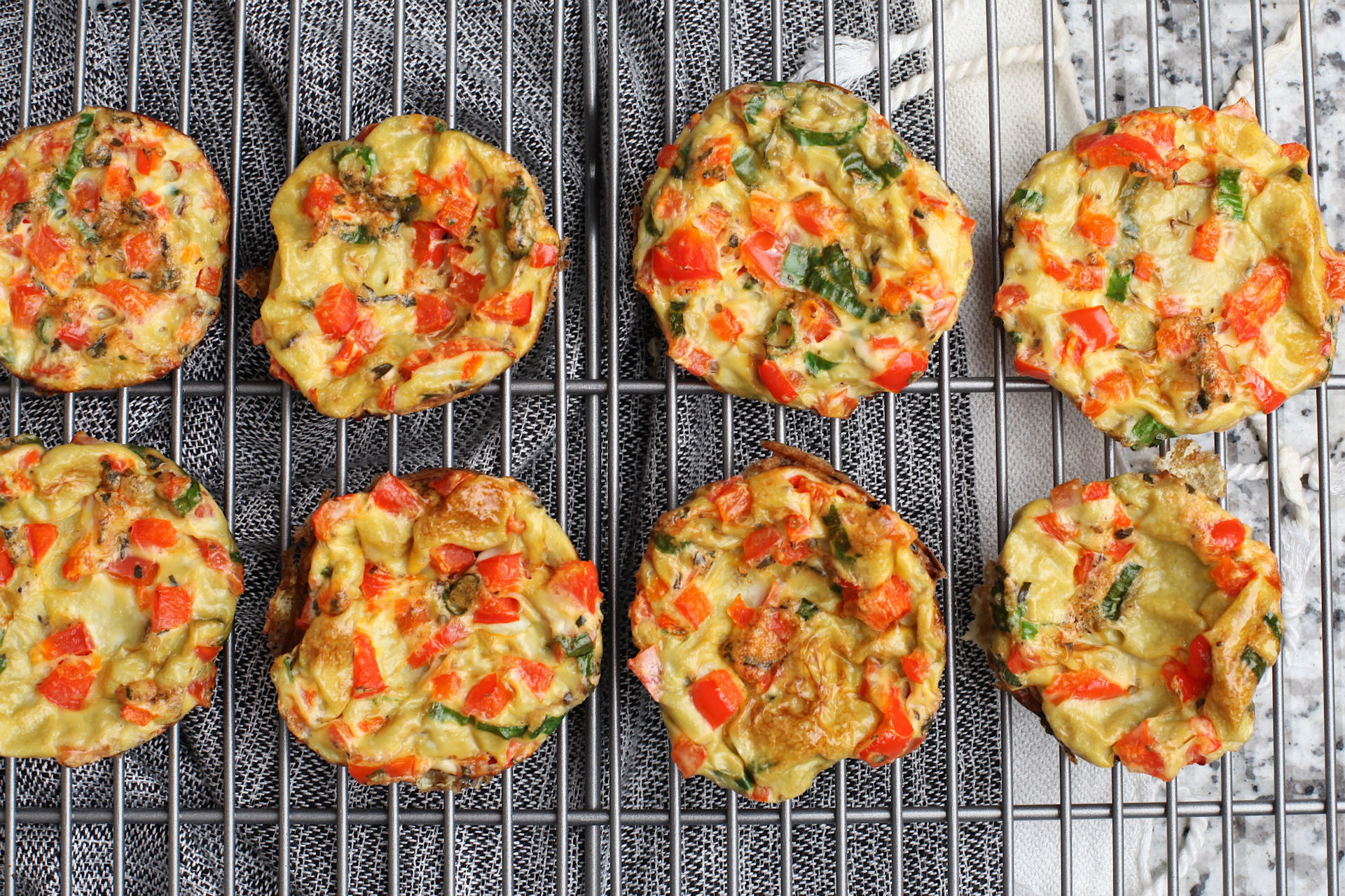 bite-sized frittatas with veggies on a cooling rack