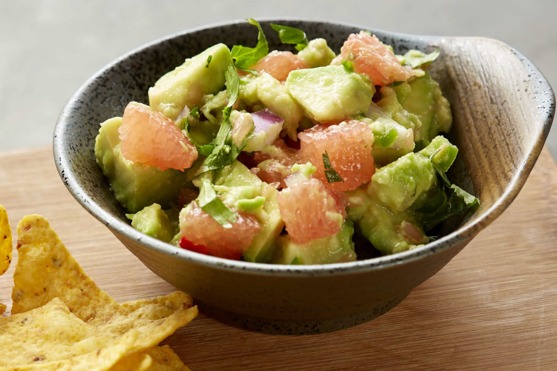 bowl of guacamole with tortilla chips