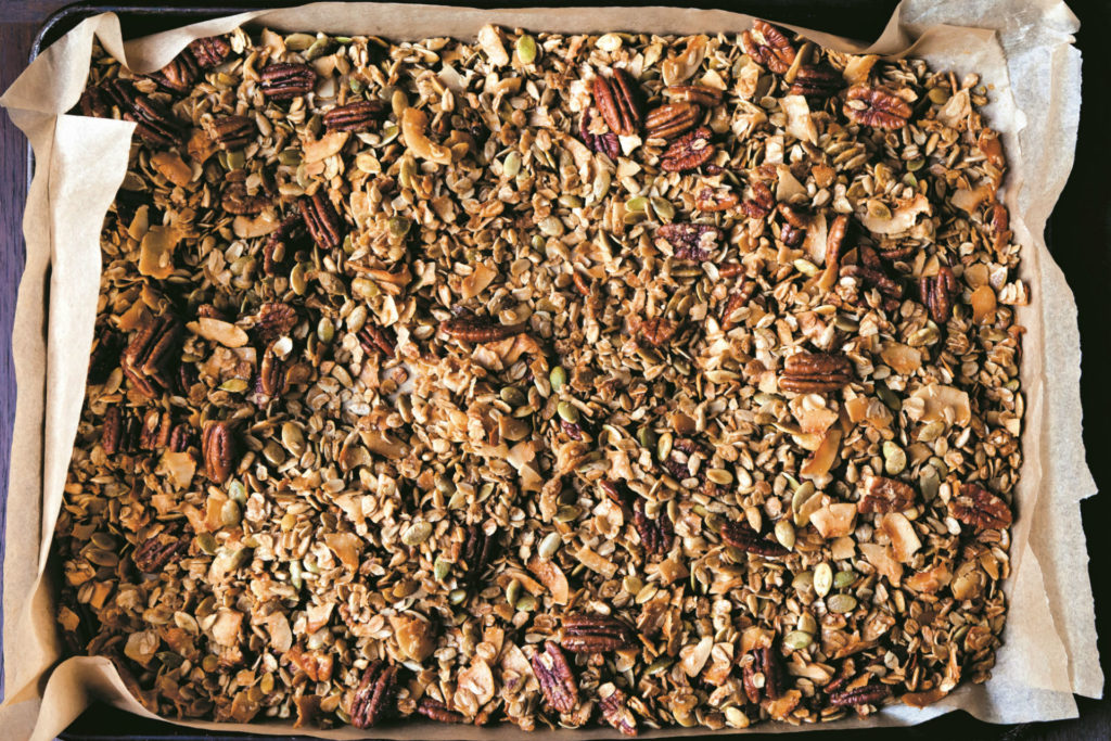 baking sheet of granola with nuts, seeds and coconut