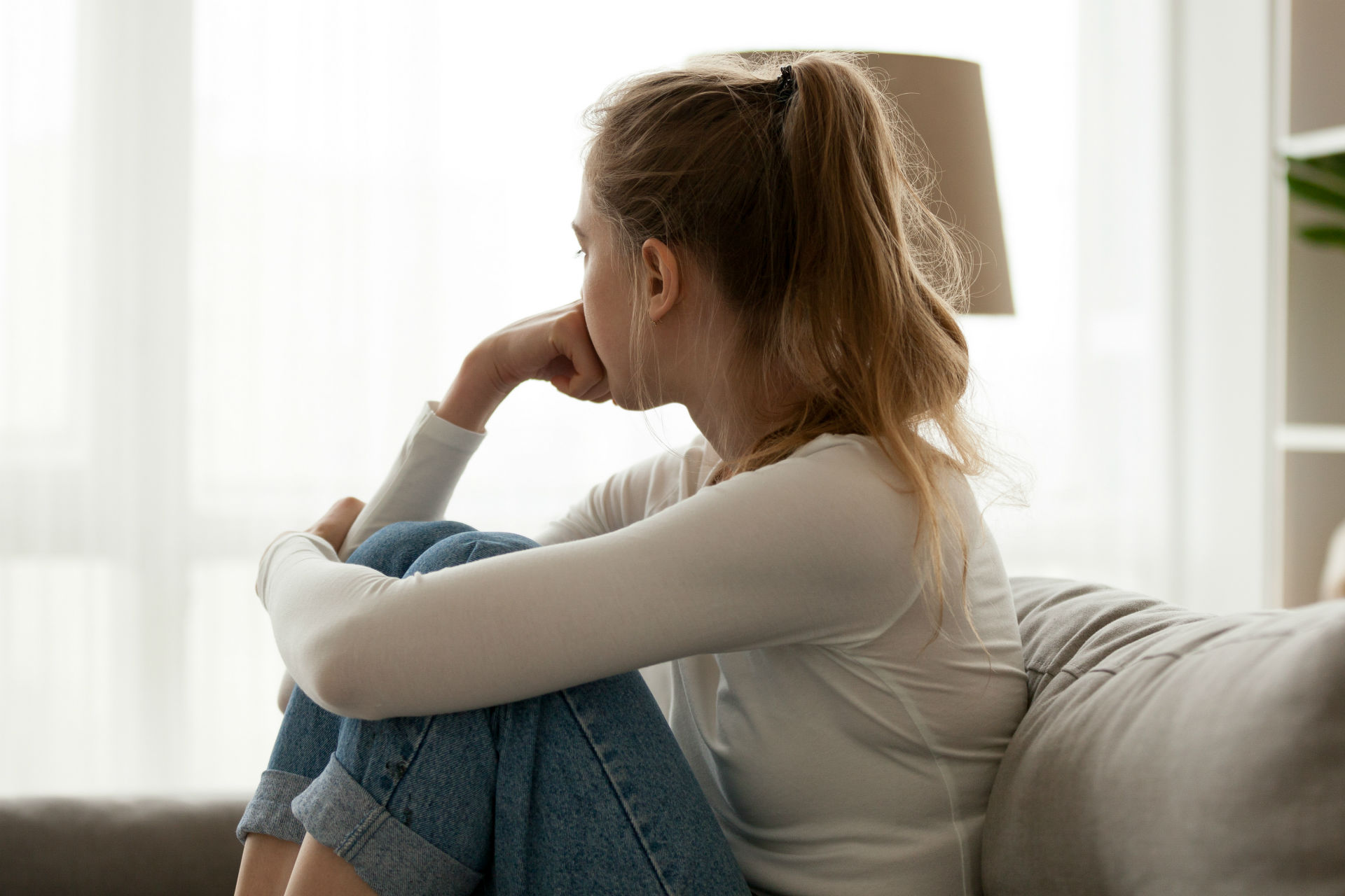 girl on couch looking depressed