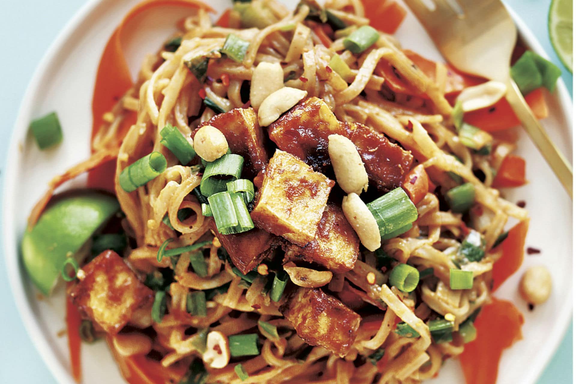 plate of pad thai with tofu and chopped peanuts