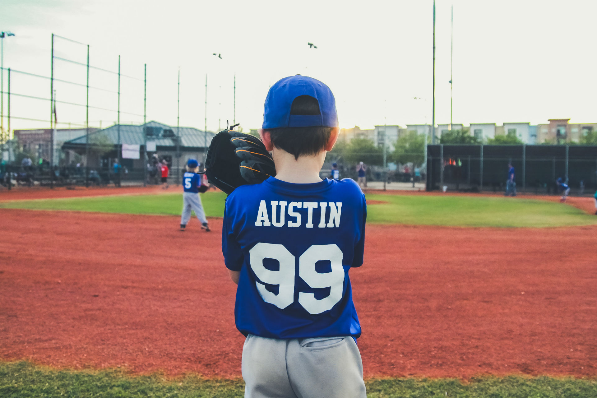 little boy on pitchers mound of a baseball field