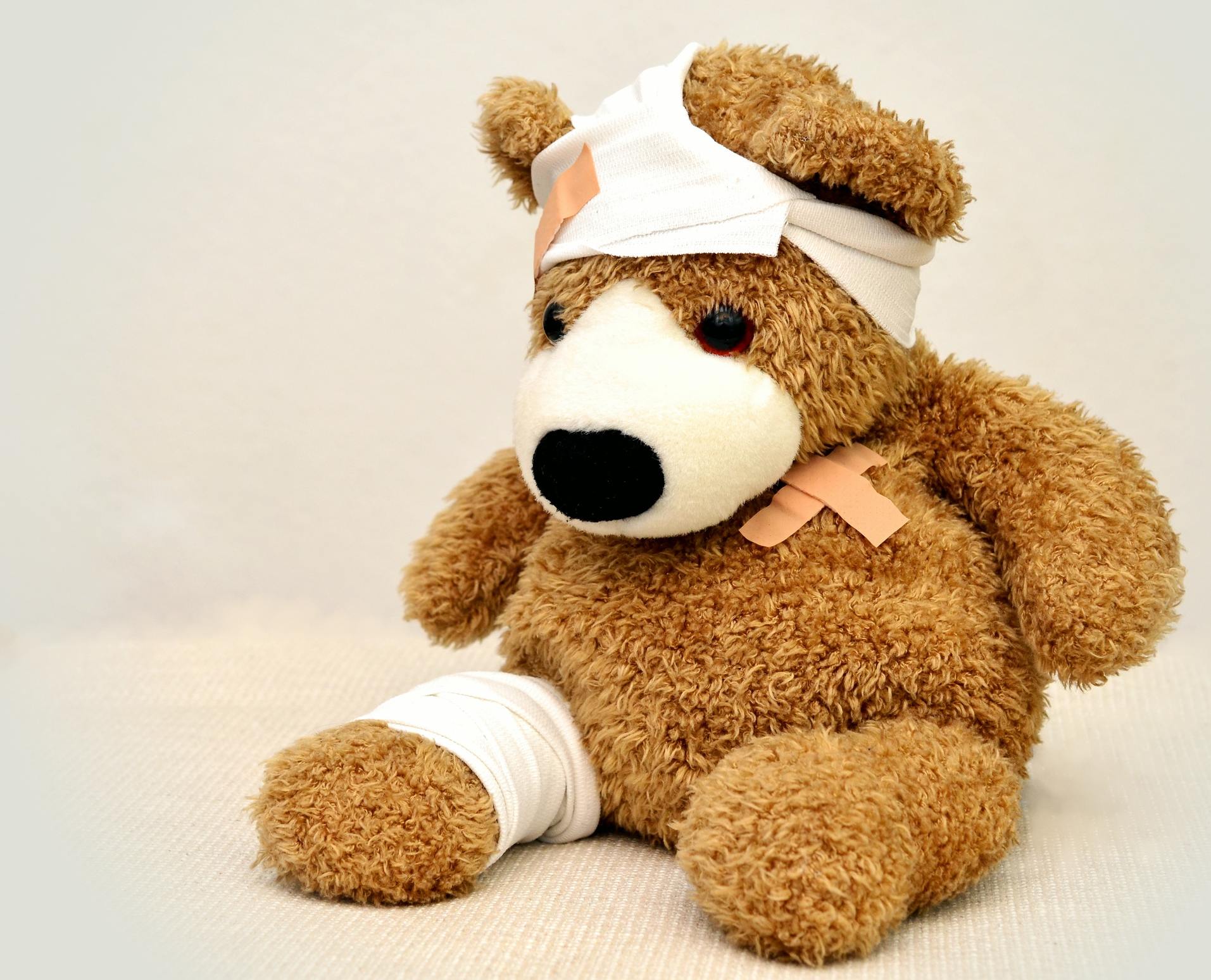 Teddy bear with bandages and bandaids