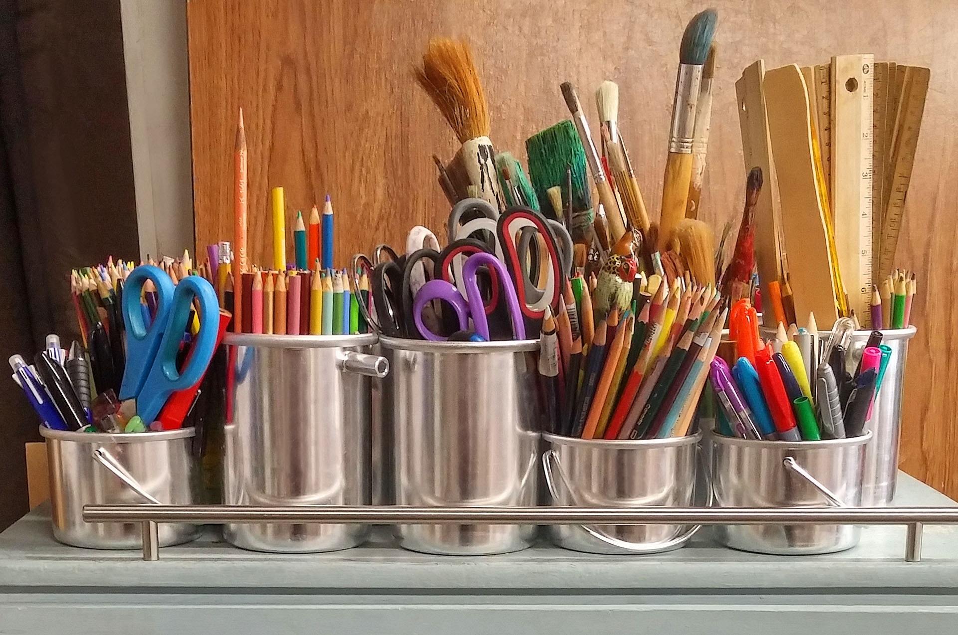 Row of craft supplies in stainless steel pots
