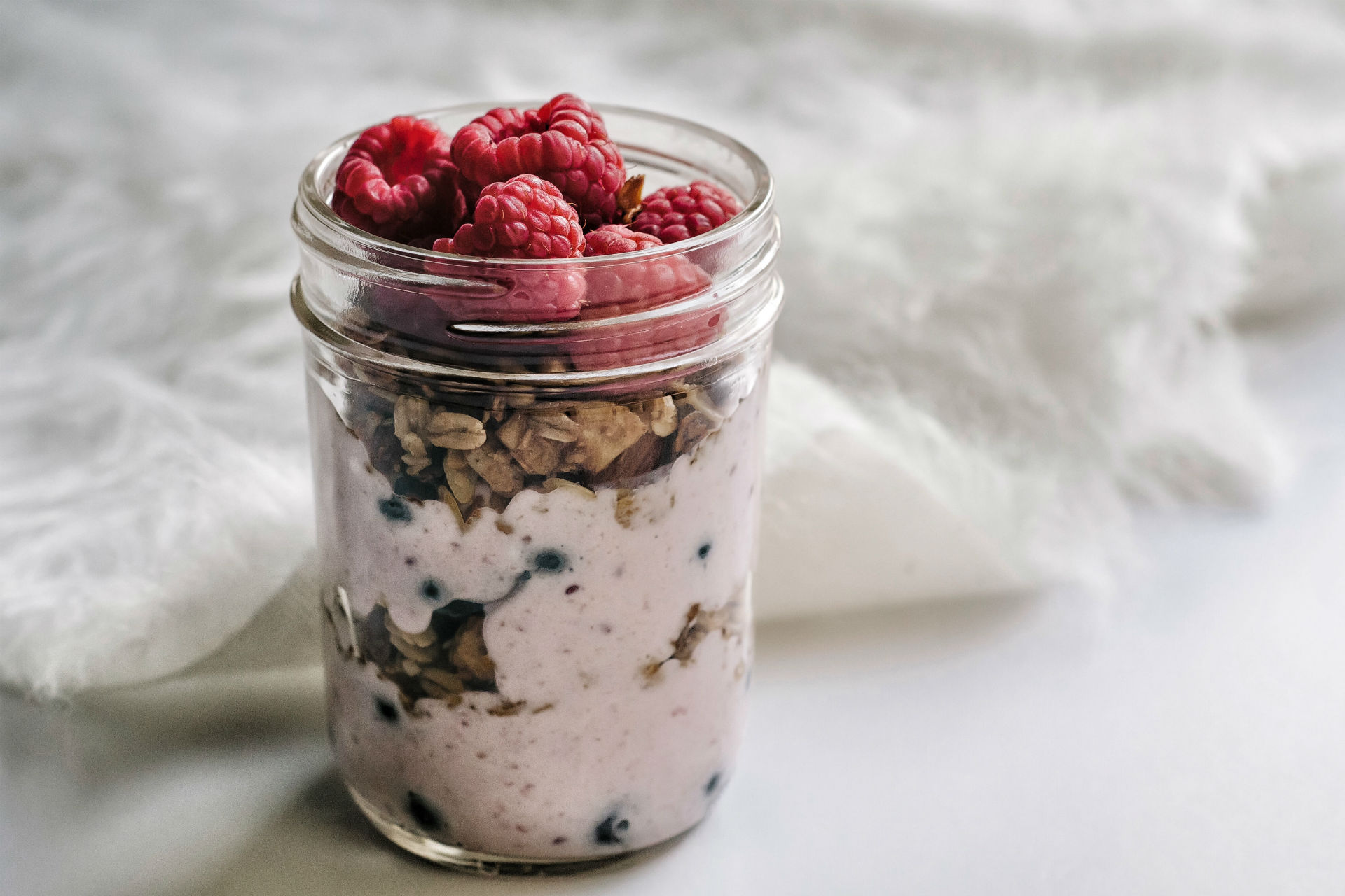yogurt, berries and granola in a mason jar