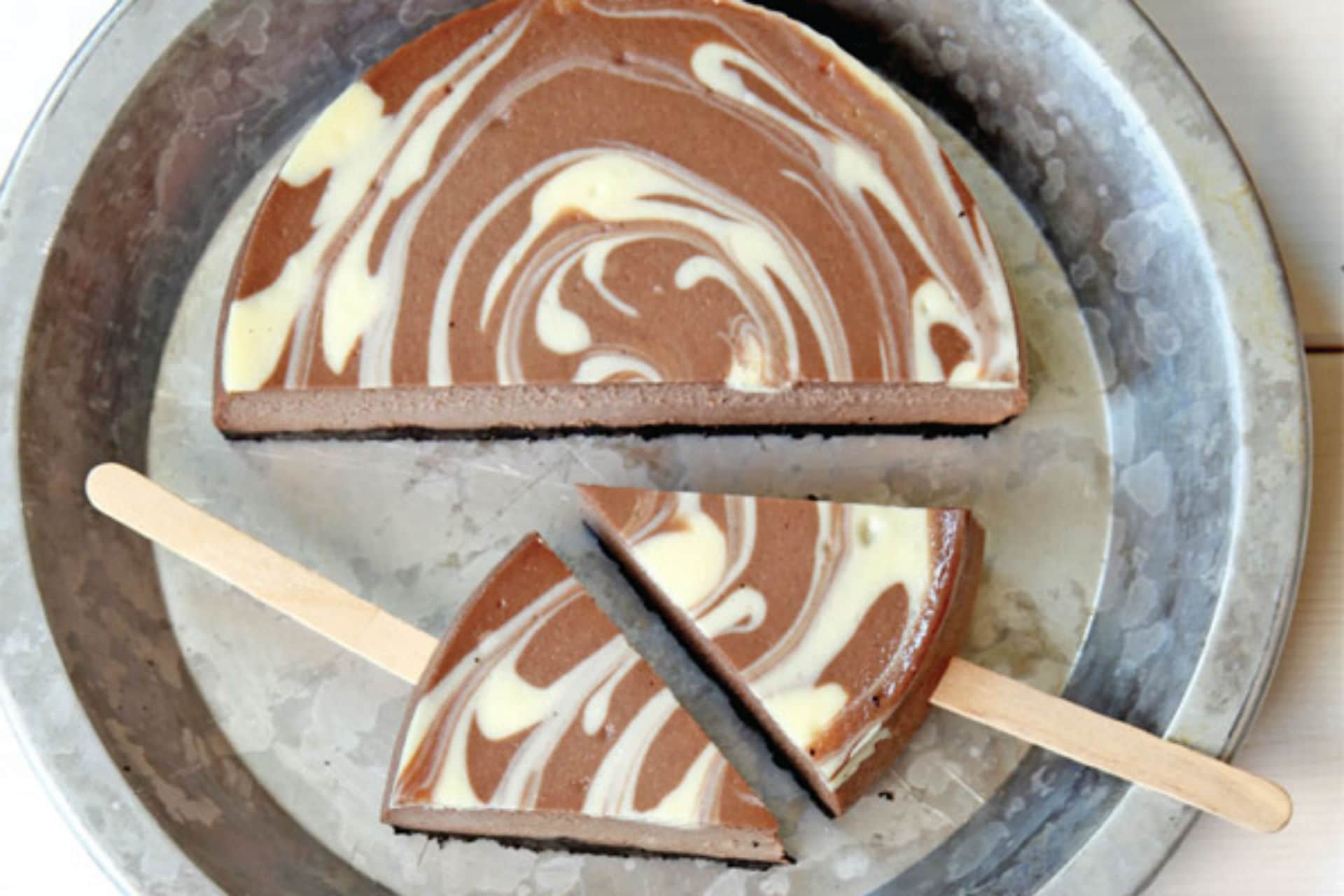 cheesecake slices with popsicle stick through it