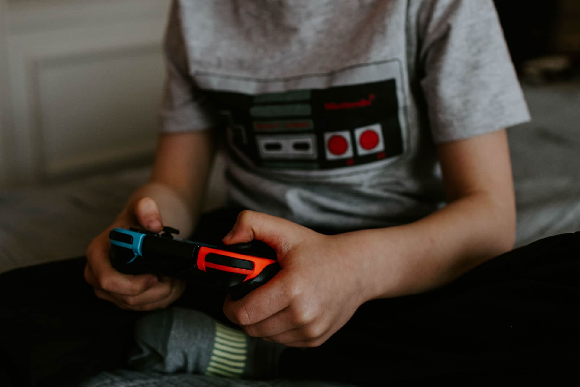 kid playing a video game with controller in hand