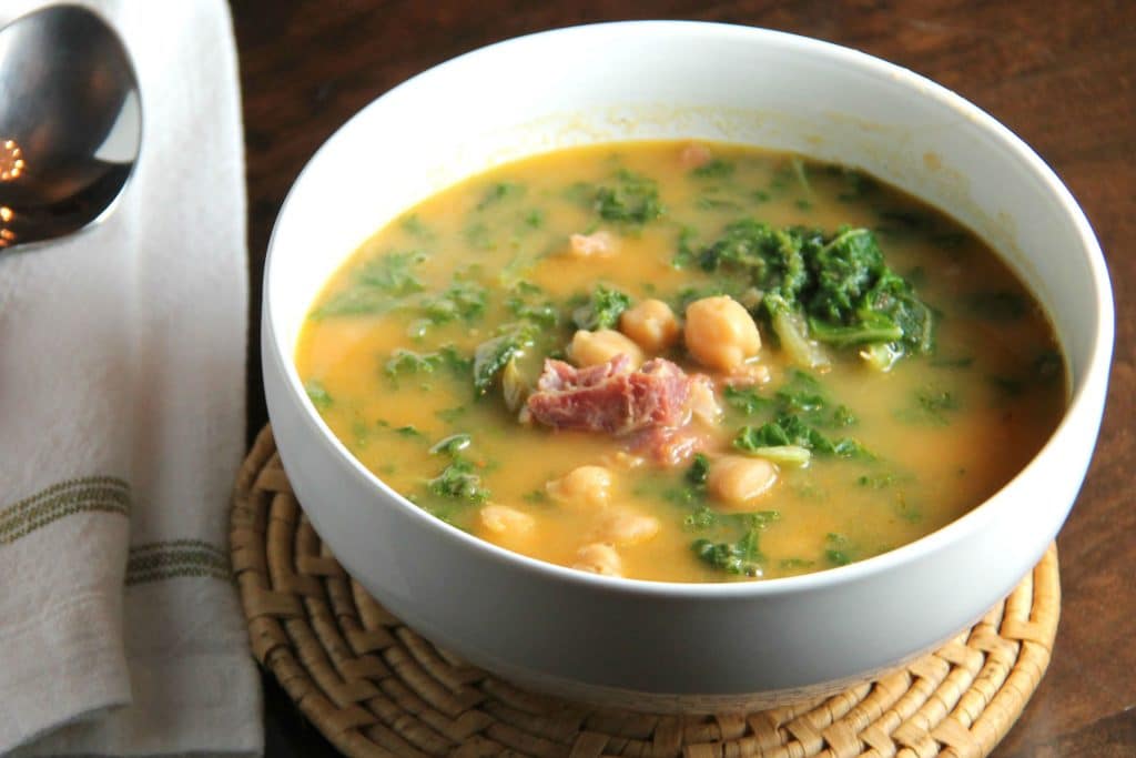 bowl of soup with chickpeas, kale and ham