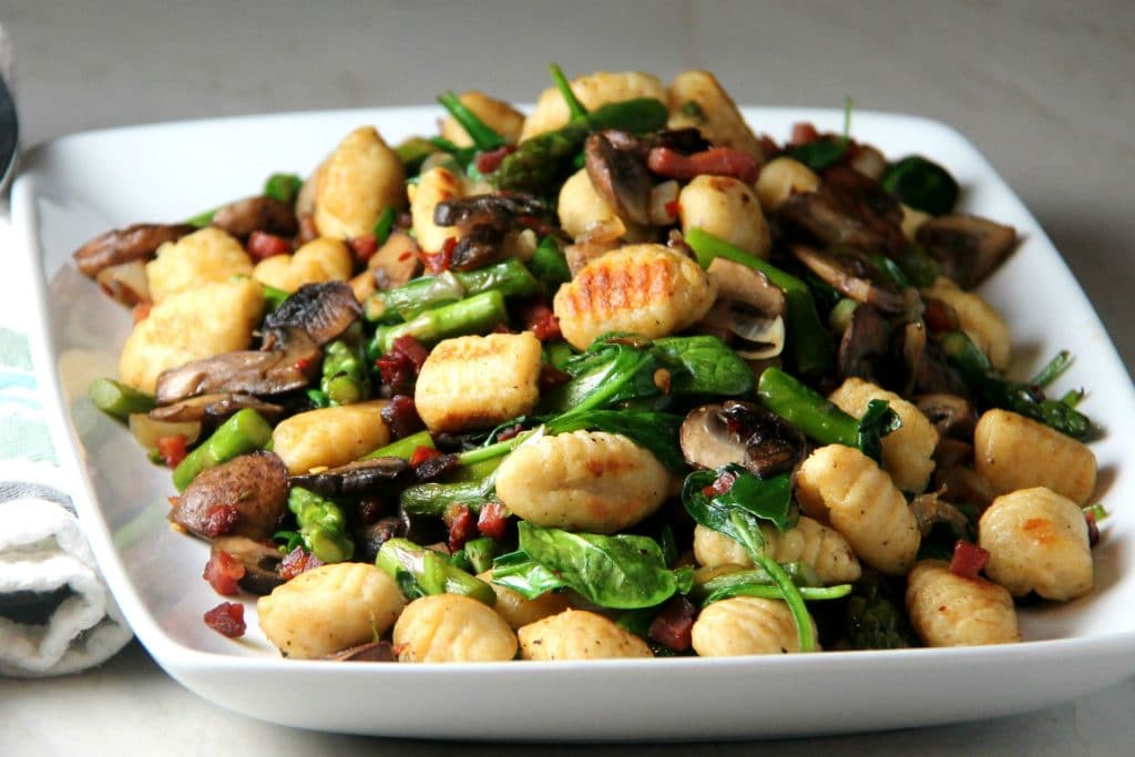 plate of gnocchi with sauteed veggies and pancetta