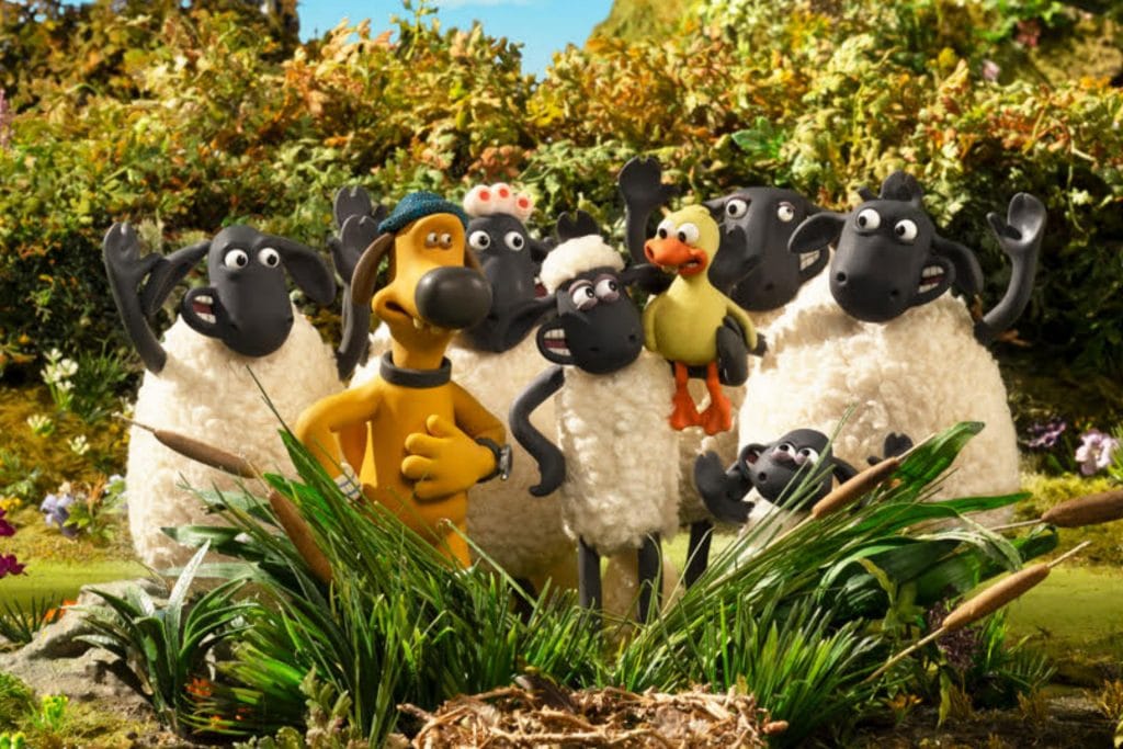still from the stop-motion movie shaun of the sheep of a group of sheep posing in the bushes