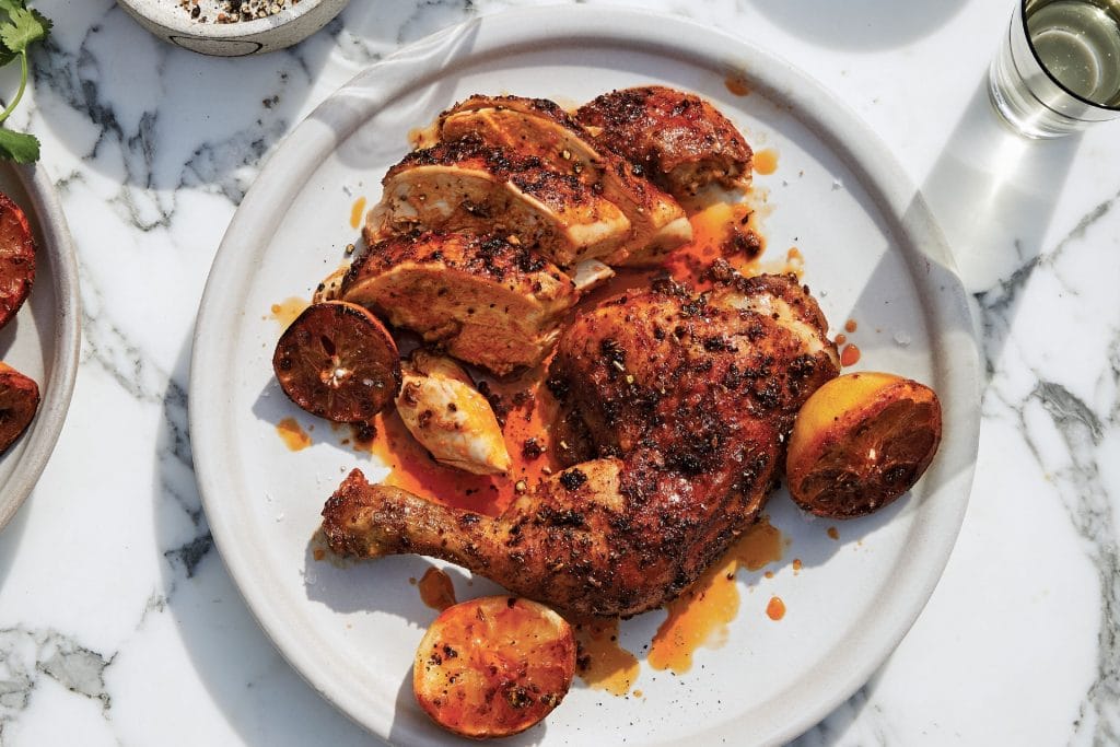 chicken covered in a paprika rub with roasted lemons