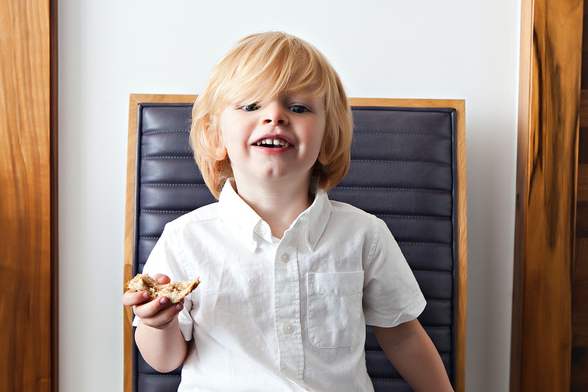 little boy holding a snack