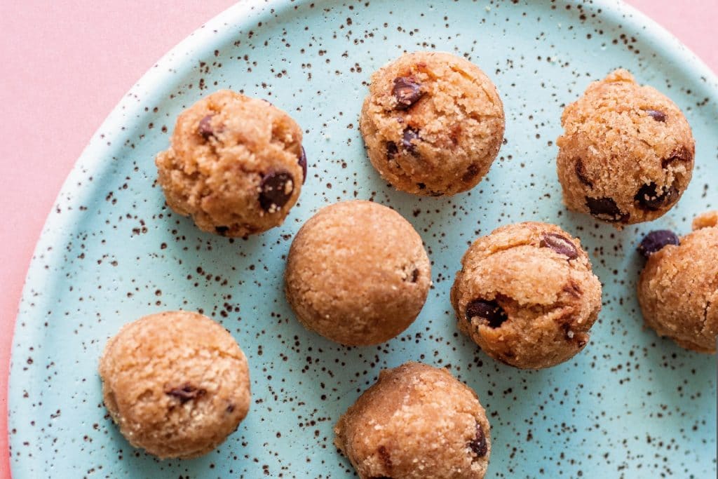 cookie dough balls on a blue plate