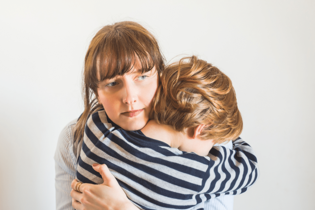 woman hugging a kid