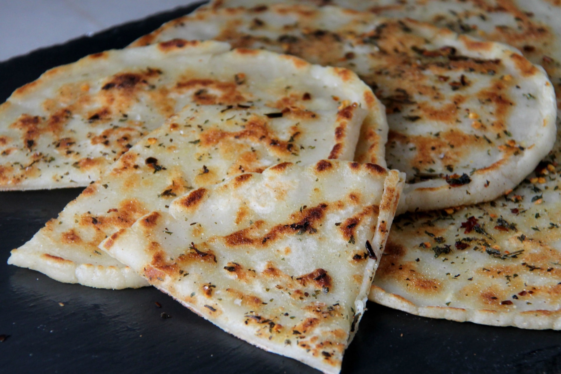 flatbread with spices cut on a plate