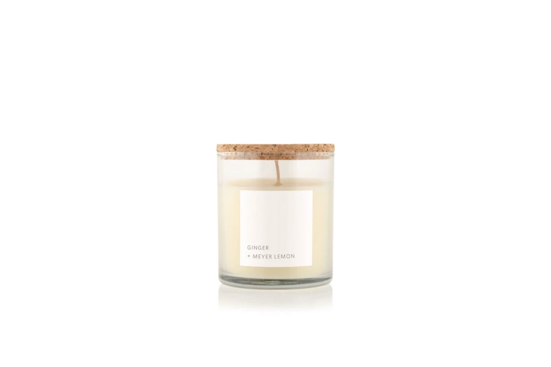 cream coloured candle with cork lid and white label