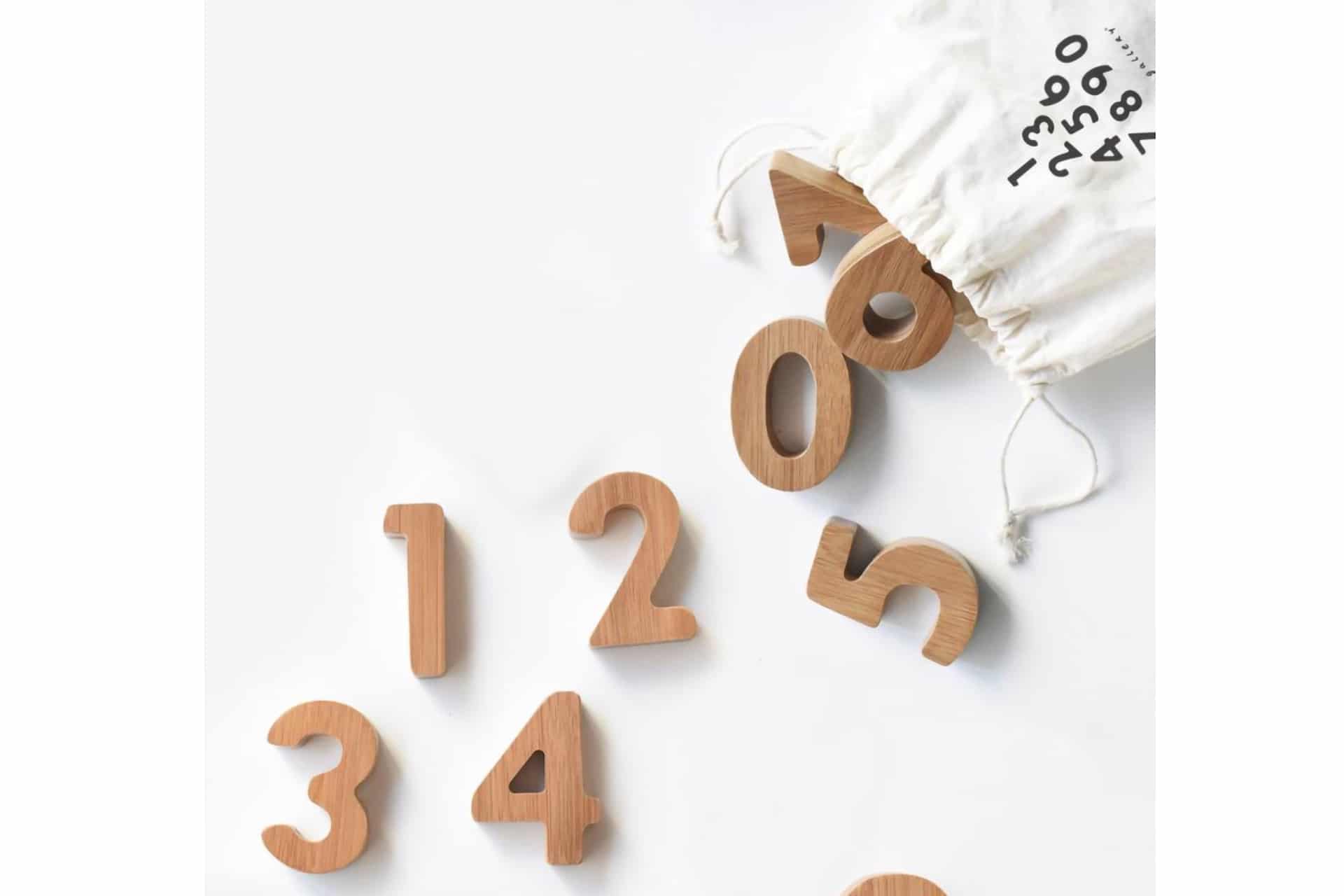 wooden numbers coming out of a cloth bag
