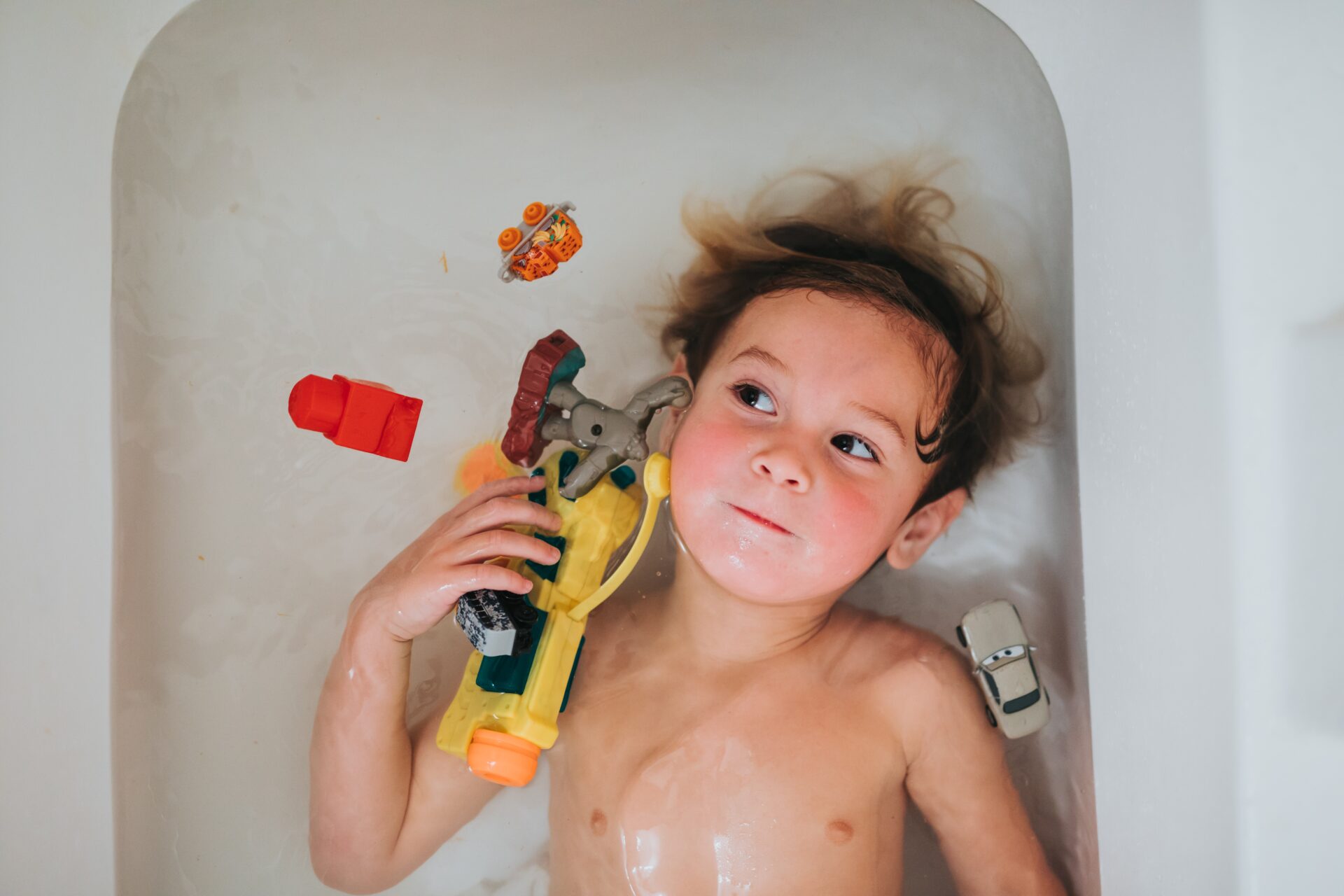boy in tub with toys