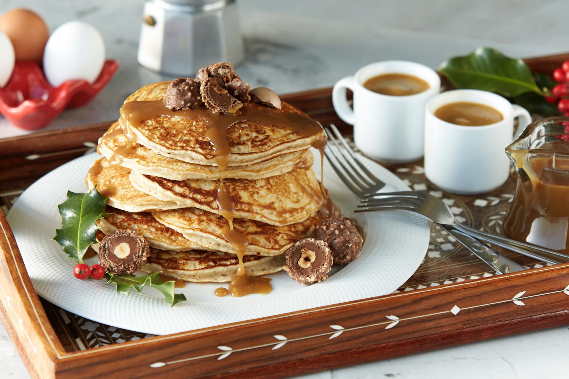 plate of pancakes with caramel sauce and chocolates