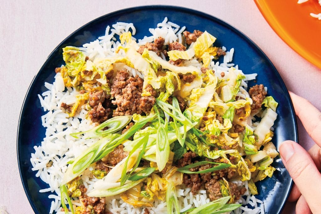 Sticky Korean Beef recipe shown as a plate of ground beef and shredded cabbage over rice