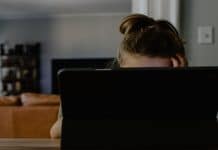 Want to Make Virtual School More Sustainable? Adjust the Expectations Woman with ponytail obscured by computer screen