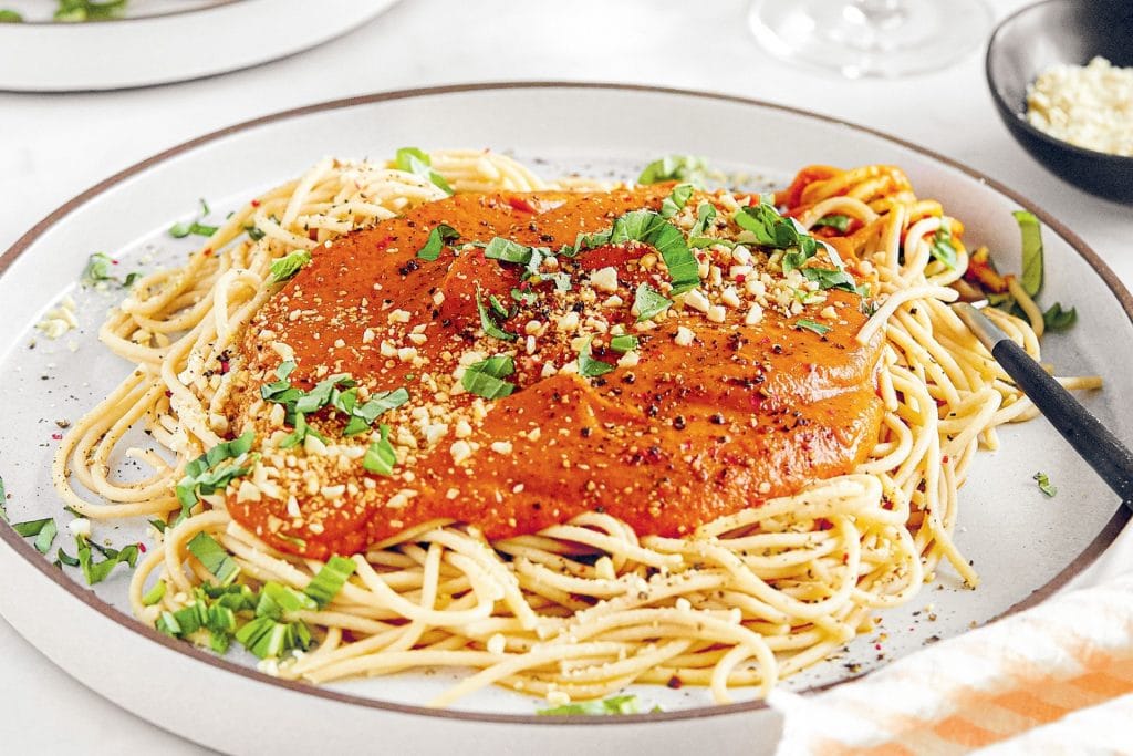 Plate of spaghetti with tomato sauce and garnish